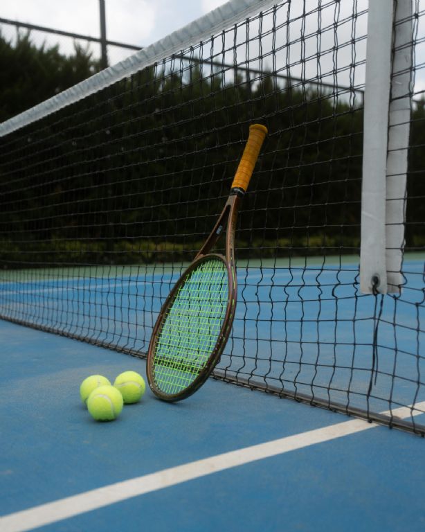 Tennis Court with tennis rackets and tennis balls 